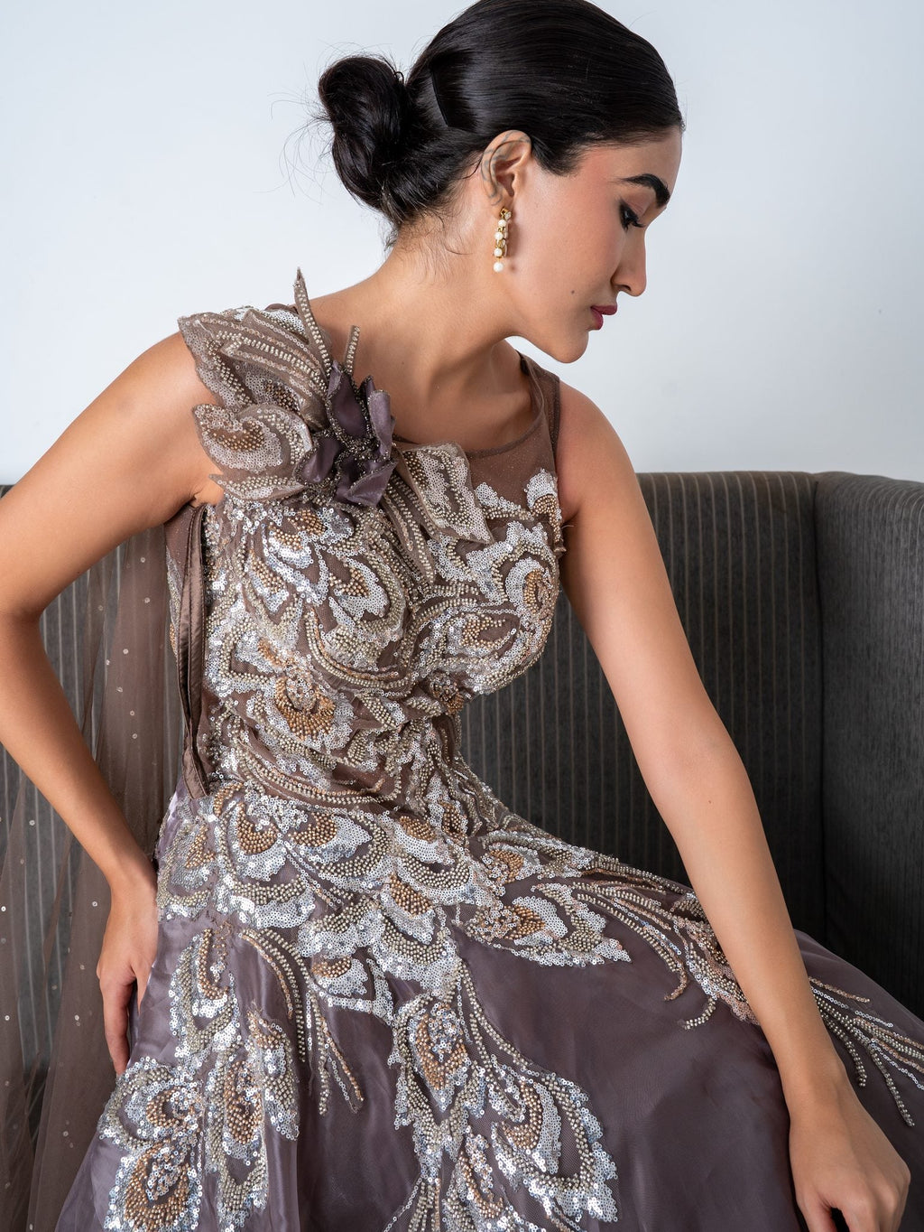 Mauve embellished gown, seated, full length
