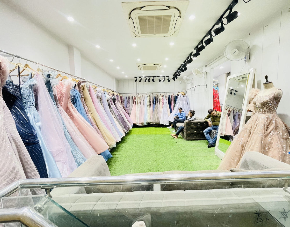 Ajmera's gown room seen from the stairs, with customers on the sofa