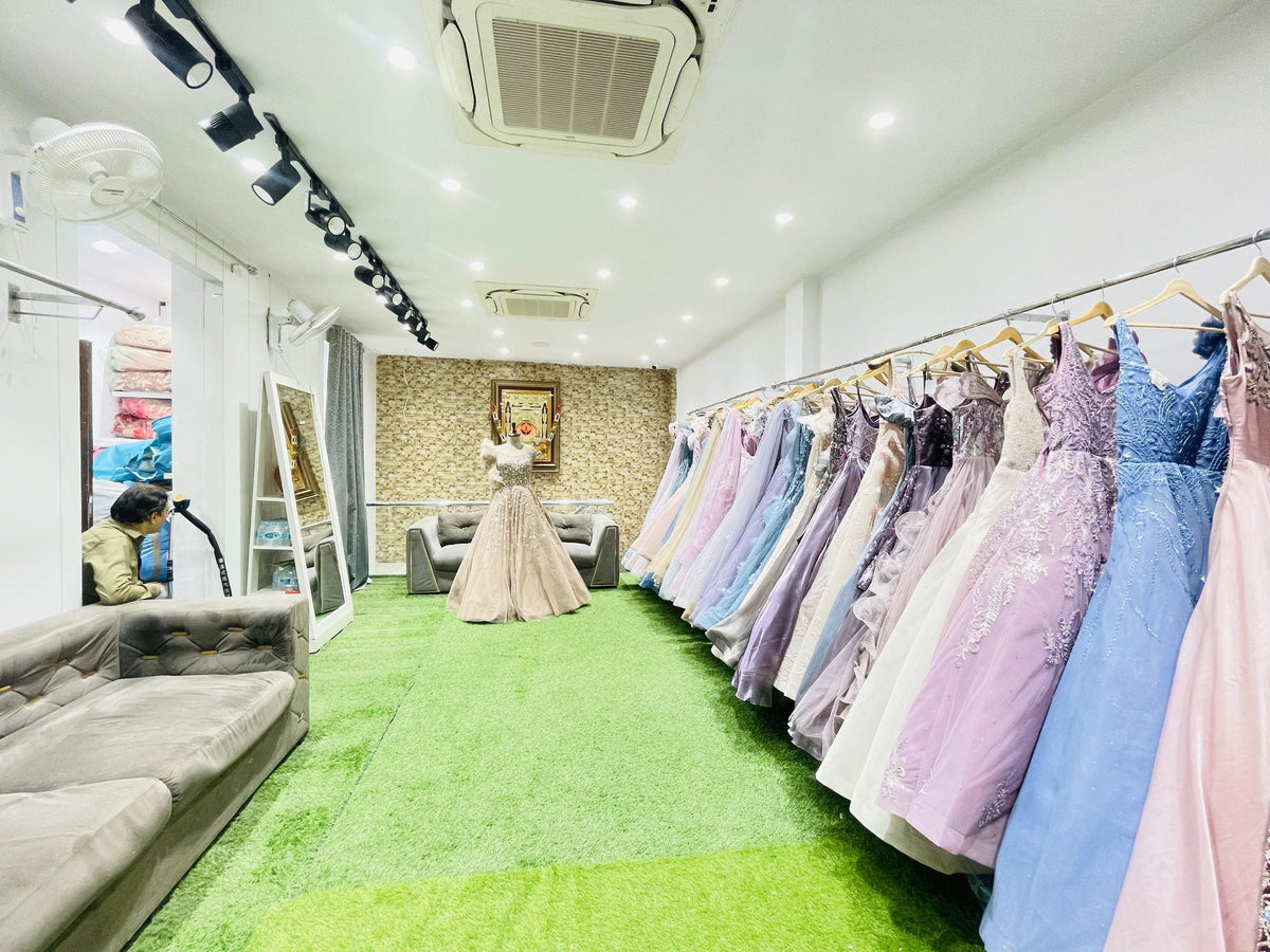 Ajmera's gown room: green turf, rails of pastel gowns and sofas